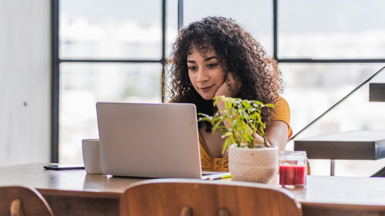 Woman sitting at table with laptop