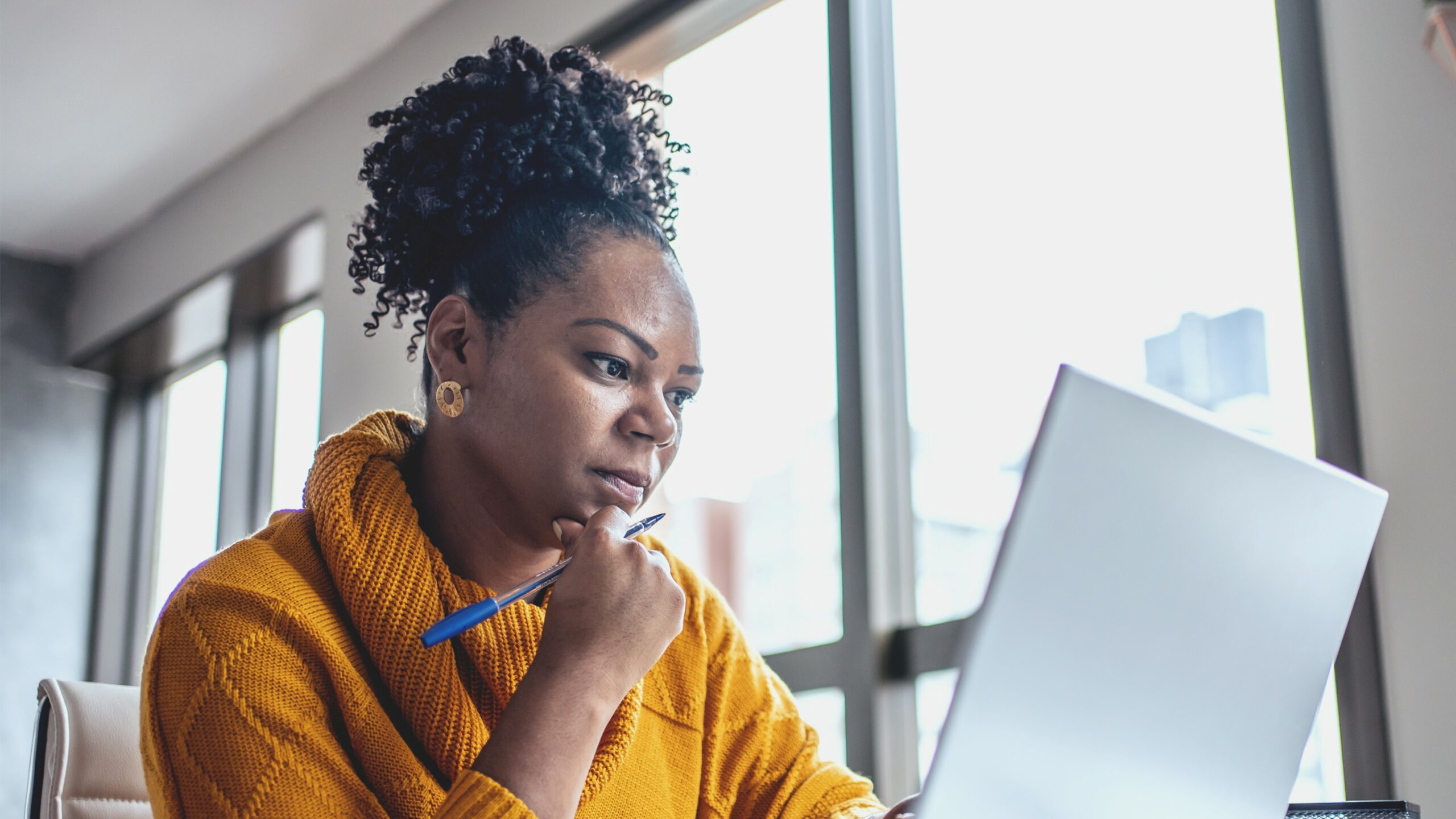 Woman looking at laptop.